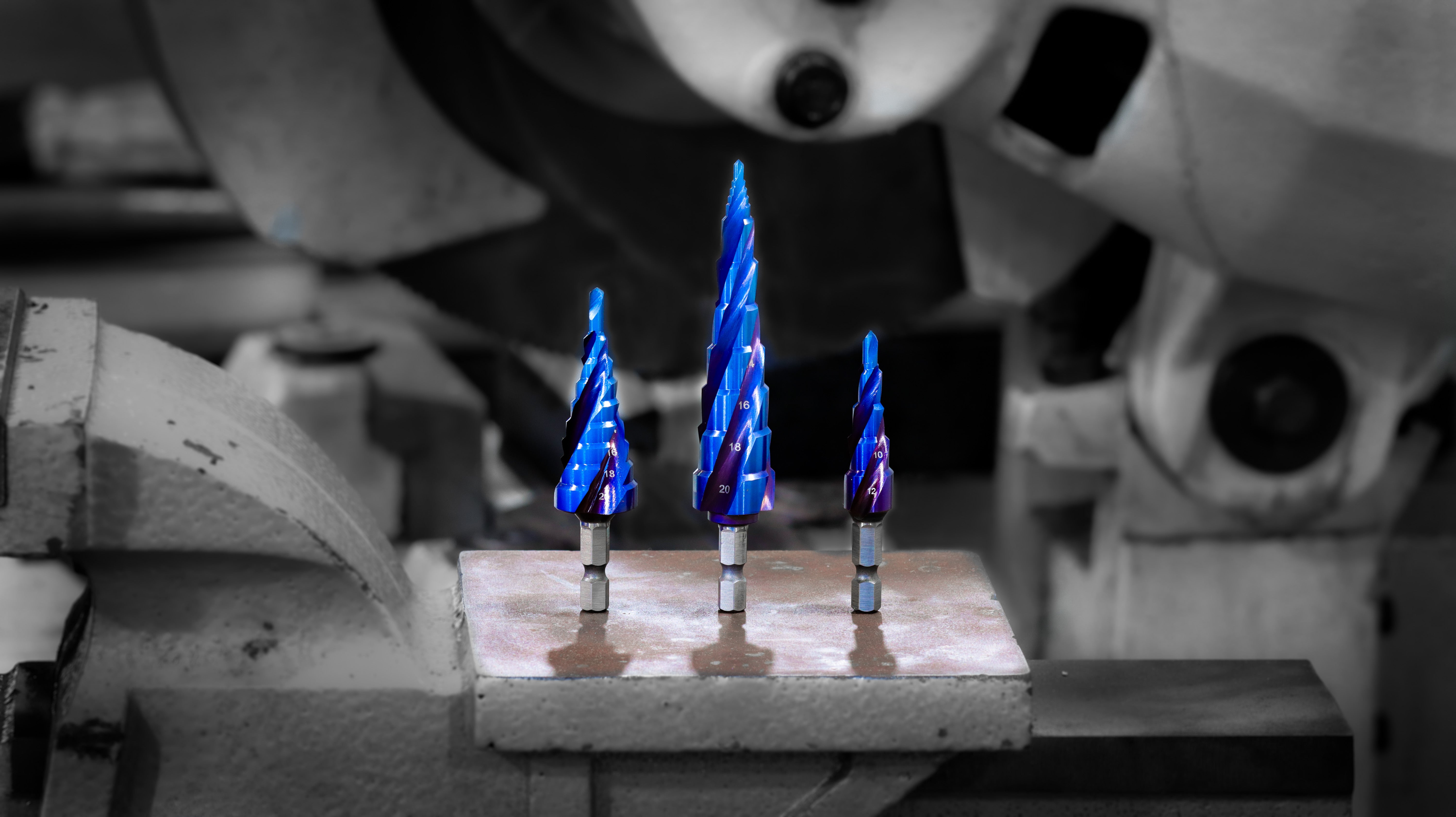 Atlas Tools Image of 3 Blue Step Bits on Steel Vice front shot